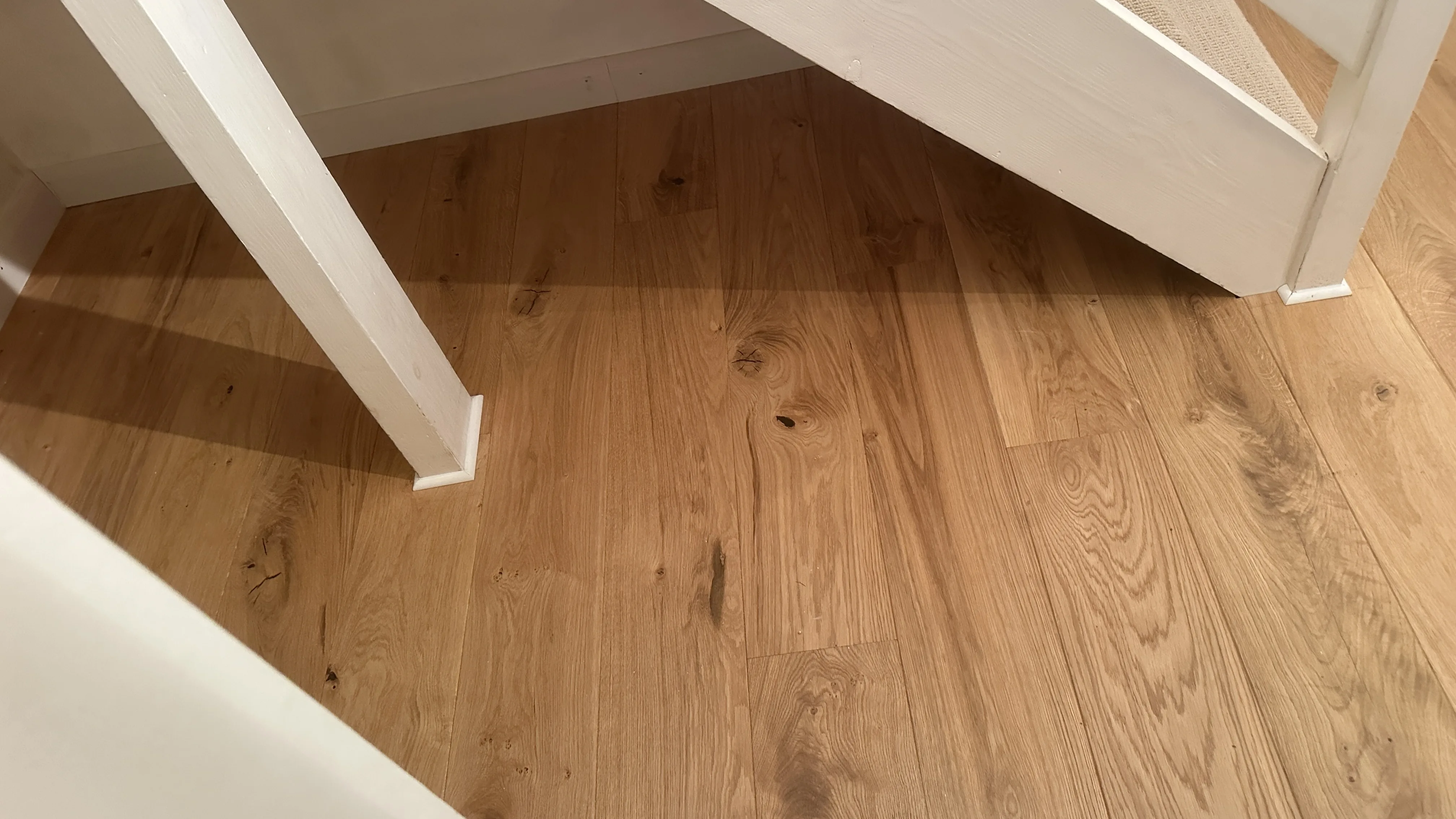 Flooring Installation project in Wallingford - a white wooden floor with a white base
