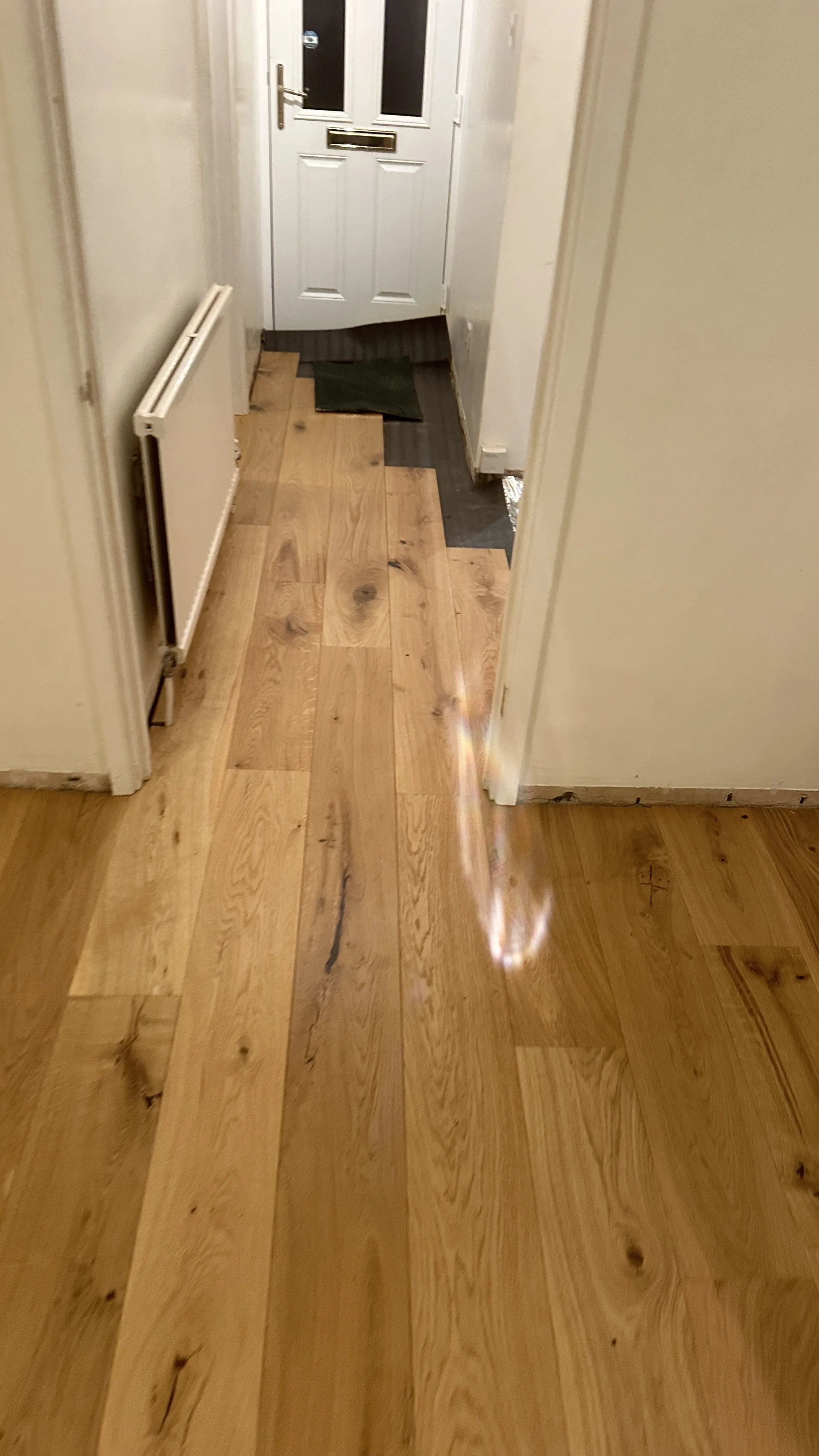 Flooring Installation project in Wallingford - a wooden floor with a white door and a white door