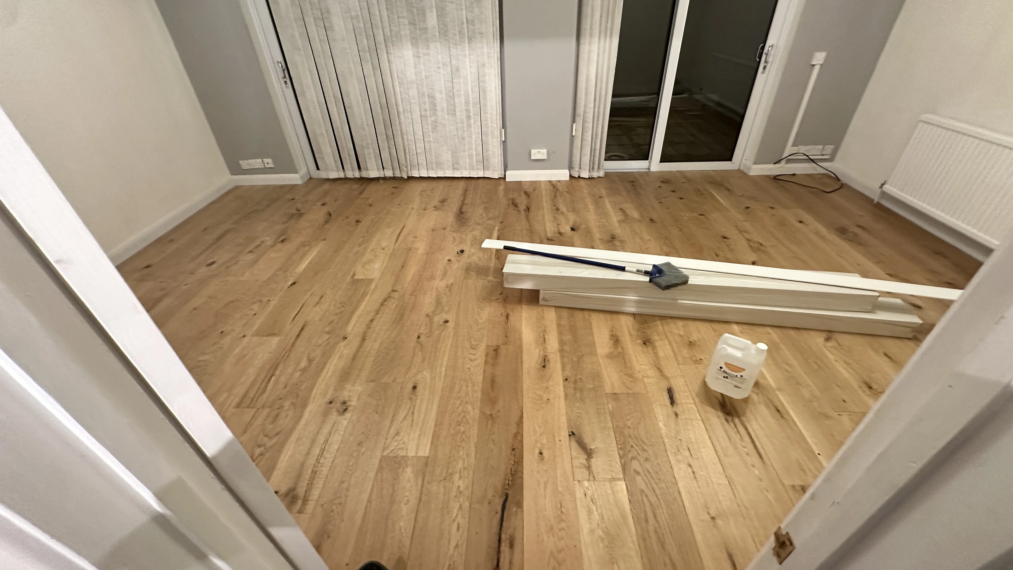 Flooring Installation project in Wantage - a wooden floor with a white trim and a white trim