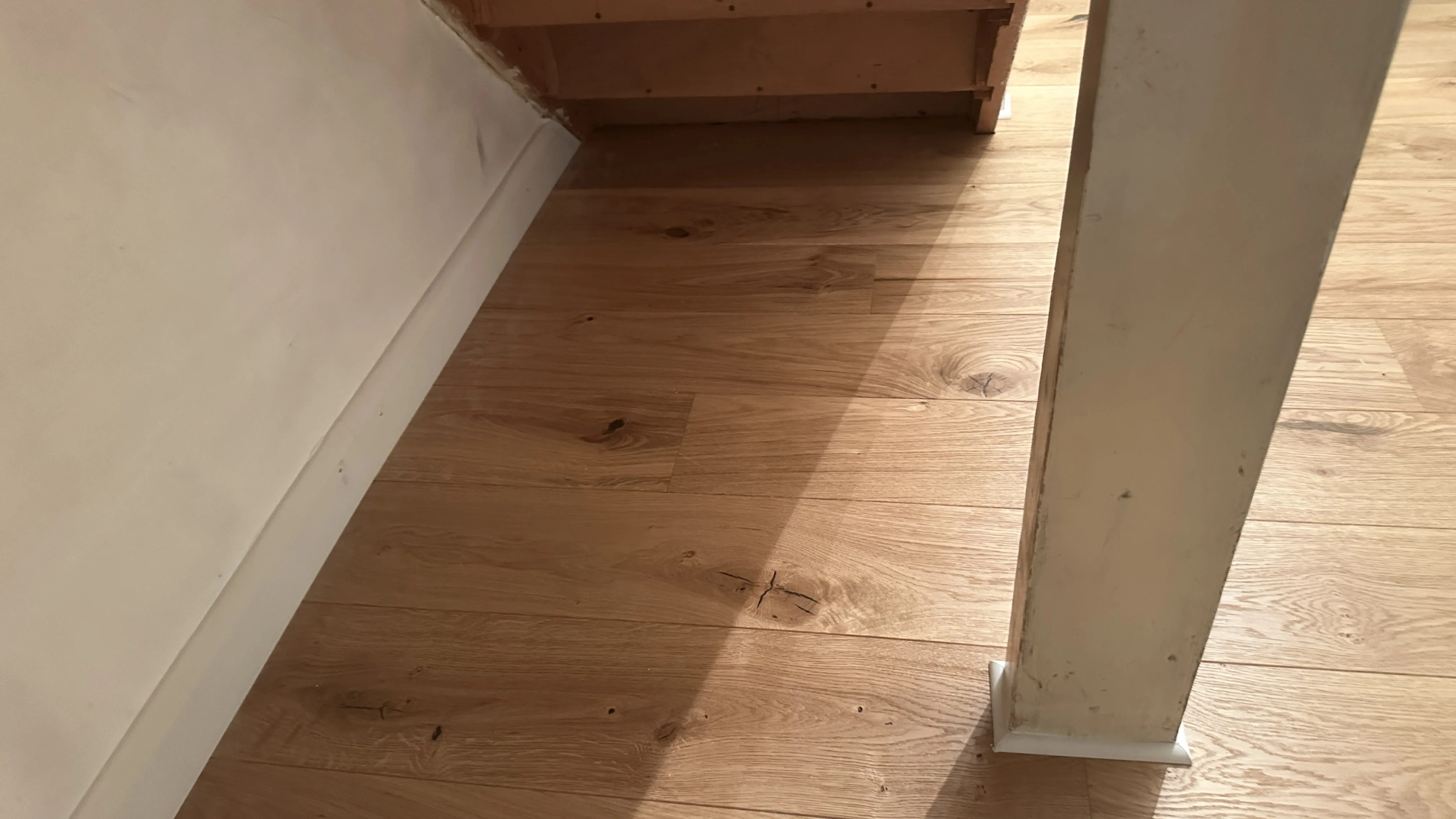 Flooring Installation project in Wantage - a wooden floor with a white wall and a white wall